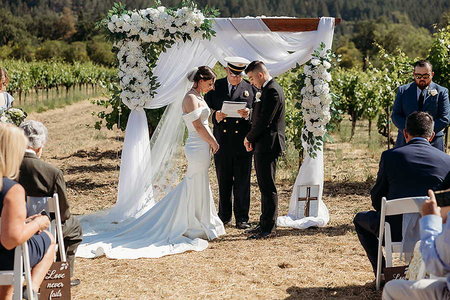 Couple exchanging vows overlooking vineyard rows in Calistoga | Napa Wedding Photographer